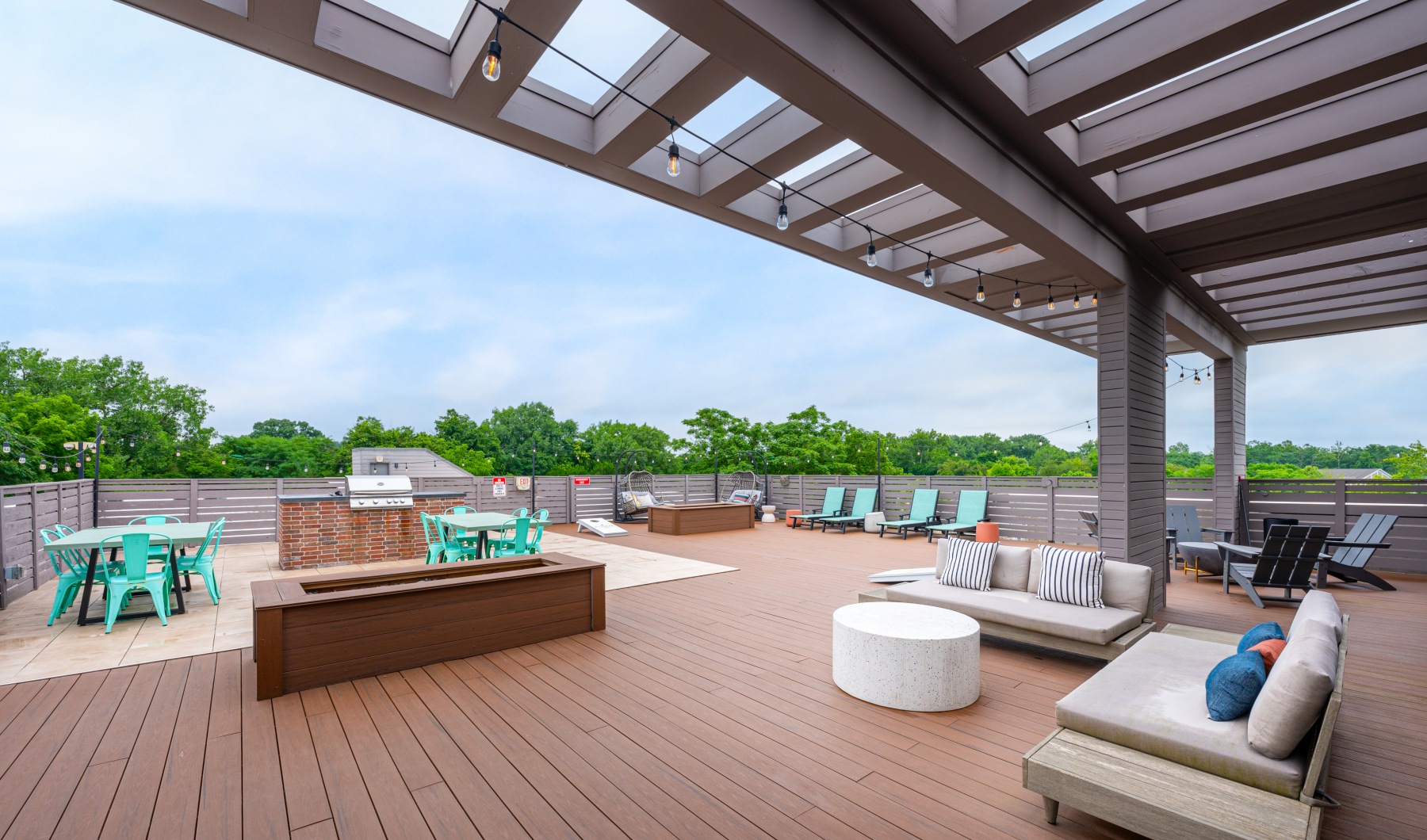 Unwind and connect on our rooftop deck Deck with furniture and grills